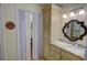 Traditional bathroom vanity with granite countertop, decorative mirror, and closet with folding doors at 500 Bainbridge Dr, Atlanta, GA 30327