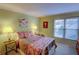 Charming bedroom with patterned bedding, lamps, and natural light from a large window at 500 Bainbridge Dr, Atlanta, GA 30327