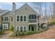 Back exterior view of condo with screened porch and staircase to raised porch at 500 Bainbridge Dr, Atlanta, GA 30327