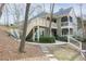 View of condo complex with exterior staircase leading to a screened porch and balcony at 500 Bainbridge Dr, Atlanta, GA 30327