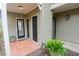 Charming front entrance with covered porch, tiled floor and black front doors at 500 Bainbridge Dr, Atlanta, GA 30327