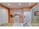 Cozy kitchen featuring light wood cabinets, granite countertops, and modern appliances at 500 Bainbridge Dr, Atlanta, GA 30327