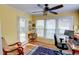 Well-lit home office with hardwood floors, a ceiling fan, and three large windows at 500 Bainbridge Dr, Atlanta, GA 30327