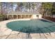 The pool is covered for the off season surrounded by trees and a cabana area at 500 Bainbridge Dr, Atlanta, GA 30327