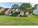 Charming backyard featuring a lush lawn, mature landscaping, and a covered porch at 1887 Lake Ridge Ter, Lawrenceville, GA 30043