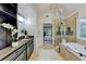 Luxurious bathroom with granite countertops, soaking tub, and glass-enclosed shower offers a spa-like retreat at 1887 Lake Ridge Ter, Lawrenceville, GA 30043