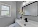 Modern bathroom features a sleek mirror, a white vanity, and natural light at 1887 Lake Ridge Ter, Lawrenceville, GA 30043