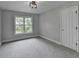 Bright bedroom with a large window offering scenic views, complemented by neutral walls and plush carpeting at 1887 Lake Ridge Ter, Lawrenceville, GA 30043