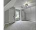 Bedroom featuring gray carpet, neutral walls, and a window to let in natural light at 1887 Lake Ridge Ter, Lawrenceville, GA 30043
