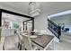 Open-concept dining room with modern lighting, wood table, and view of the kitchen and staircase at 1887 Lake Ridge Ter, Lawrenceville, GA 30043
