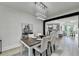 Elegant dining room with modern chandelier, wood table, and adjacent kitchen view at 1887 Lake Ridge Ter, Lawrenceville, GA 30043