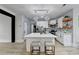 Open concept kitchen with large island, stainless steel appliances, and decorative lighting at 1887 Lake Ridge Ter, Lawrenceville, GA 30043