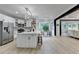 Open concept kitchen with large island, stainless steel appliances, and decorative lighting at 1887 Lake Ridge Ter, Lawrenceville, GA 30043