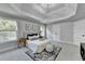Spacious main bedroom with tray ceiling, plush carpet, and large windows for natural light at 1887 Lake Ridge Ter, Lawrenceville, GA 30043