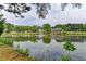 Scenic pond view with fountain, gazebo, and surrounding lush greenery, creating a serene atmosphere at 1887 Lake Ridge Ter, Lawrenceville, GA 30043