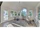 Bright sun room featuring modern lighting, lots of windows and beautiful light colored wood flooring at 1887 Lake Ridge Ter, Lawrenceville, GA 30043