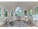 Bright sun room featuring modern lighting, lots of windows and beautiful light colored wood flooring at 1887 Lake Ridge Ter, Lawrenceville, GA 30043