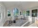 Bright sun room featuring modern lighting, lots of windows and beautiful light colored wood flooring at 1887 Lake Ridge Ter, Lawrenceville, GA 30043