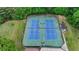 Aerial view of community tennis courts surrounded by trees and landscaping at 1887 Lake Ridge Ter, Lawrenceville, GA 30043