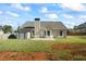 Back of the home features a small shed, concrete patio and a fenced yard at 127 Cranbrooke Dr, Dallas, GA 30157