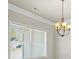 Bright dining room with a modern chandelier and natural light at 127 Cranbrooke Dr, Dallas, GA 30157