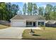 Inviting single-story home with a two-car garage and a charming front yard at 127 Cranbrooke Dr, Dallas, GA 30157
