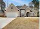 Charming home with a two-car garage and manicured lawn at 253 Yardsley Dr, Mcdonough, GA 30253