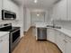 Modern kitchen featuring stainless steel appliances and white cabinets at 253 Yardsley Dr, Mcdonough, GA 30253