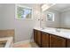 Bathroom with a double vanity, large mirror, and picture window bringing in lots of light at 3066 Quantum Ln # 24, Atlanta, GA 30341