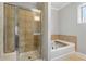 The bathroom features a glass enclosed shower and soaking tub with tiled surround at 3066 Quantum Ln # 24, Atlanta, GA 30341