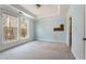 Bright bedroom with tray ceiling, two windows, and neutral carpet ready for personalization at 3066 Quantum Ln # 24, Atlanta, GA 30341