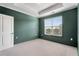 Bedroom featuring a bright window, base molding, and tray ceiling at 3066 Quantum Ln # 24, Atlanta, GA 30341