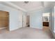 Spacious primary bedroom featuring tray ceiling, plush carpet, ensuite bathroom, and walk-in closet at 3066 Quantum Ln # 24, Atlanta, GA 30341