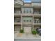 Townhome featuring individual garages and balconies, offering both convenience and outdoor living at 3066 Quantum Ln # 24, Atlanta, GA 30341