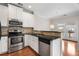 Well-lit kitchen featuring stainless steel appliances, granite countertops, and access to outdoor living space at 3066 Quantum Ln # 24, Atlanta, GA 30341
