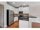 Bright kitchen with white cabinets, stainless steel appliances, and a breakfast bar overlooking the dining area at 3066 Quantum Ln # 24, Atlanta, GA 30341