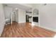 Open-concept living room with hardwood floors and fireplace, seamlessly flowing into the kitchen at 3066 Quantum Ln # 24, Atlanta, GA 30341