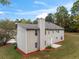 Rear of a two-story house with a well-maintained lawn and mature trees in the background at 3529 Riverview Approach, Ellenwood, GA 30294
