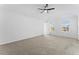 Spacious carpeted bedroom features a ceiling fan and two bright, natural light-filled windows at 3529 Riverview Approach, Ellenwood, GA 30294
