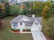 Classic two-story home with a well-kept lawn, mature trees, and a two-car garage at 3529 Riverview Approach, Ellenwood, GA 30294