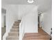 Bright foyer featuring a staircase with white railing and wood-look flooring at 3529 Riverview Approach, Ellenwood, GA 30294