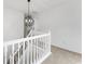 Hallway boasting a modern chandelier and white railing, adding a touch of elegance to the home's interior at 3529 Riverview Approach, Ellenwood, GA 30294