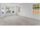 Bright living room with plush carpeting and large windows offering natural lighting at 3529 Riverview Approach, Ellenwood, GA 30294