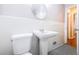 Bathroom featuring pedestal sink, white tile, checkered floors, and a bright, clean design at 1251 Richland Sw Rd, Atlanta, GA 30310