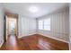 Bedroom with hardwood floors, a closet, a window, and paneled walls at 1251 Richland Sw Rd, Atlanta, GA 30310