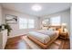Cozy bedroom with hardwood floors, neutral walls, two windows, and a comfortable bed with stylish decor at 1251 Richland Sw Rd, Atlanta, GA 30310