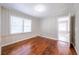 Bedroom with hardwood floors, paneled walls, and a window letting in natural light at 1251 Richland Sw Rd, Atlanta, GA 30310