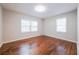 Bright bedroom with hardwood floors and two windows providing natural light at 1251 Richland Sw Rd, Atlanta, GA 30310