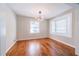 Bright dining room features hardwood floors, large window, and modern light fixture at 1251 Richland Sw Rd, Atlanta, GA 30310
