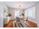 Cozy dining area featuring a round table, striped chairs, and bright bay window at 1251 Richland Sw Rd, Atlanta, GA 30310